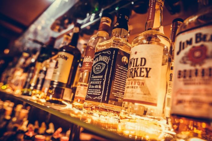 Liquor bottles on package store shelves. Photo/Shutterstock.