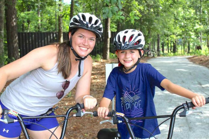 Maddie Burke and campers learn to ride bikes on the camp's brand new bike and pump track.