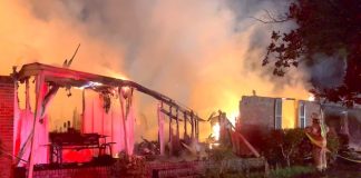 A Fayette County firefighter (at right) was part of a 5-station response to the fire early Wednesday morning in Tyrone. No injuries were reported. Photo/Fayette County Fire Department.