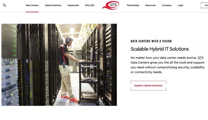 A data center employee checks a bank of servers in a routine maintenance operation. Photo/QTS website.