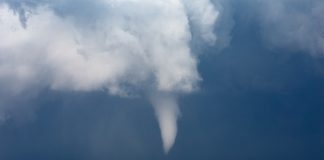 Funnel cloud over field. Shutterstock image.