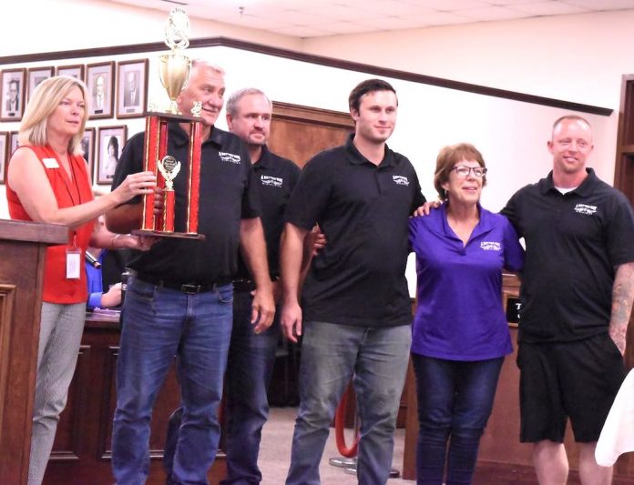 Mayor Kim Learnard presents top award to A Better Way Ministries representatives at the City Council meeting July 13. The group won the Grand Marshal Trophy for the 4th of July Parade. Photo/Cal Beverly.