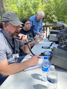 Jack Parks (KO4WBM) and Bryan Macera (K7CPT) operating a portable ham radio station during a club picnic. Photo/Joe Domaleski