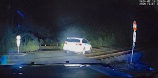 Police dash cam photo of a car parked on railroad tracks. Photo/Peachtree City Police Department.