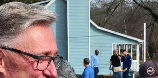 Ms. Derryl Anderson (with Rick Halbert) looks on as her new home receives finishing touches. Photo/City of Fayetteville, Ga.