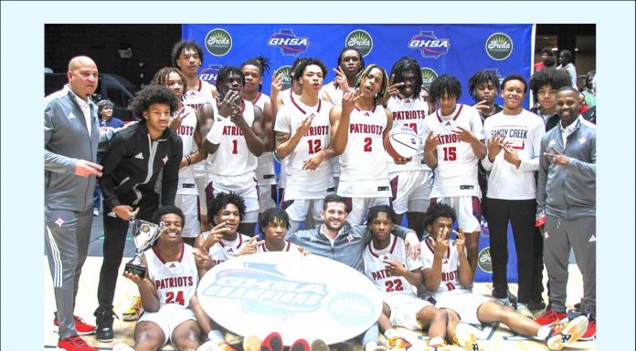 Sandy Creek High School boys basketball team and coaches show off their 2024 state championship title. Photo/Fayette County School System.