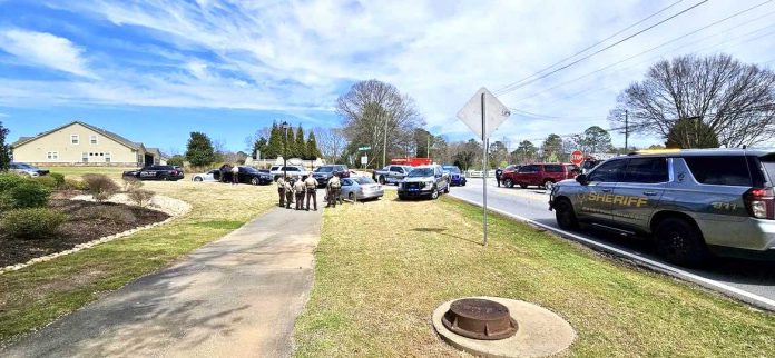 Officers compare notes after chase and arrest of carjacking juvenile. Photo/Fayette County Sheriff's Office