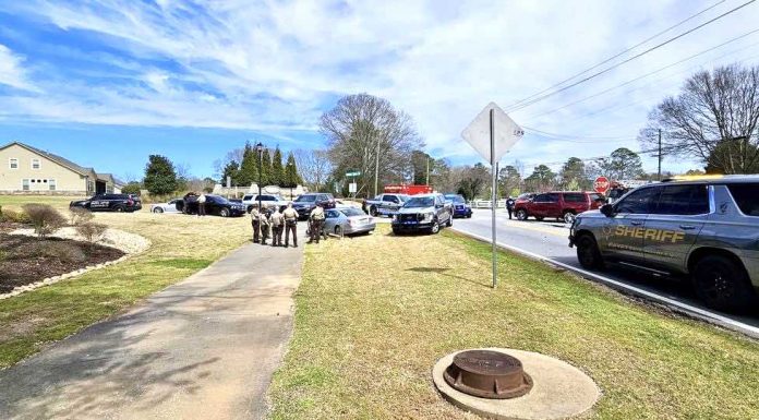 Officers compare notes after chase and arrest of carjacking juvenile. Photo/Fayette County Sheriff's Office