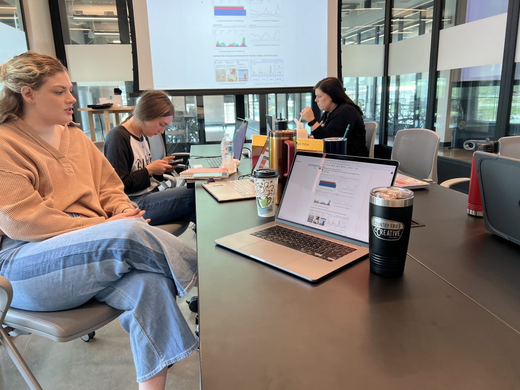 CFC team members - Kylee Veres, Mia Scarbrough, and Hollie Holder reviewing "the dream" during a recent marketing meeting at Trilith. Photo/Joe Domaleski