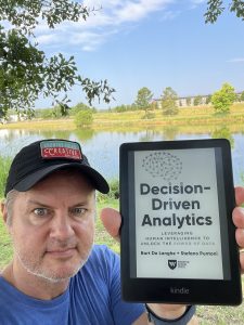 Joe Domaleski holding the Kindle e-book version of Bart De Langhe and Stefano Puntoni's new book "Decision-Driven Analytics" (Wharton School Press, June 2024). Photo/Joe Domaleski