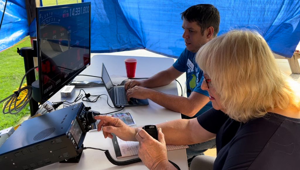 Marie Wood (KJ4IHL) and Bryan Macera (K7CPT) talk to radio stations around the world using amateur (ham) radio during the 2023 Field Day event. Photo/Joe Domaleski