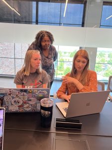 CFC team members (L-R) Erica Caetano, Fran Glass, and Christina Colantonio work on the style and substance of a marketing campaign. Photo/Joe Domaleski