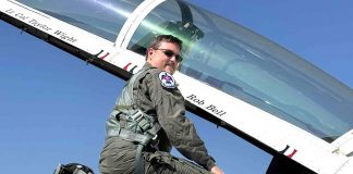 Fayette’s 2024 Teacher of the Year Rob Bell climbs into the cockpit bearing his name. Photo/Fayette County School System.