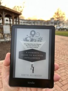 Reading Professor Hosanagar's book on my Kindle in downtown Fayetteville. Photo/Joe Domaleski