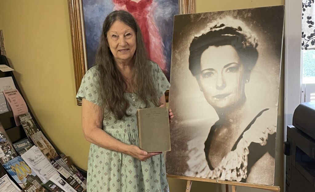 Debi Riddle from the Fayette County Historical Society holds a first print edition of Gone with the Wind signed and donated by Margaret Mitchell in 1936, the year it was published.