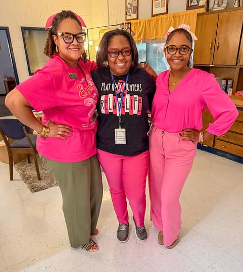 Three Flat Rock Middle staff members wearing pink for Pink Out.