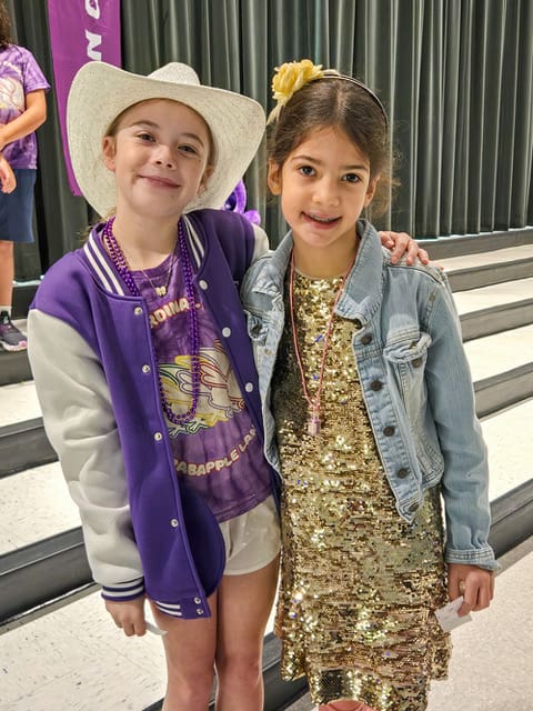 Two students in cowboy hat and sequins for Dolly Day