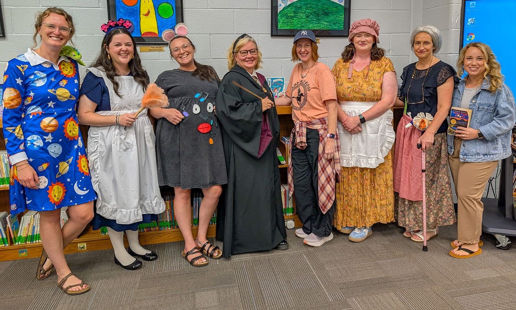 Crabapple Lane Elementary teachers dressed as book characters pose together at Camp Read-A-Lot