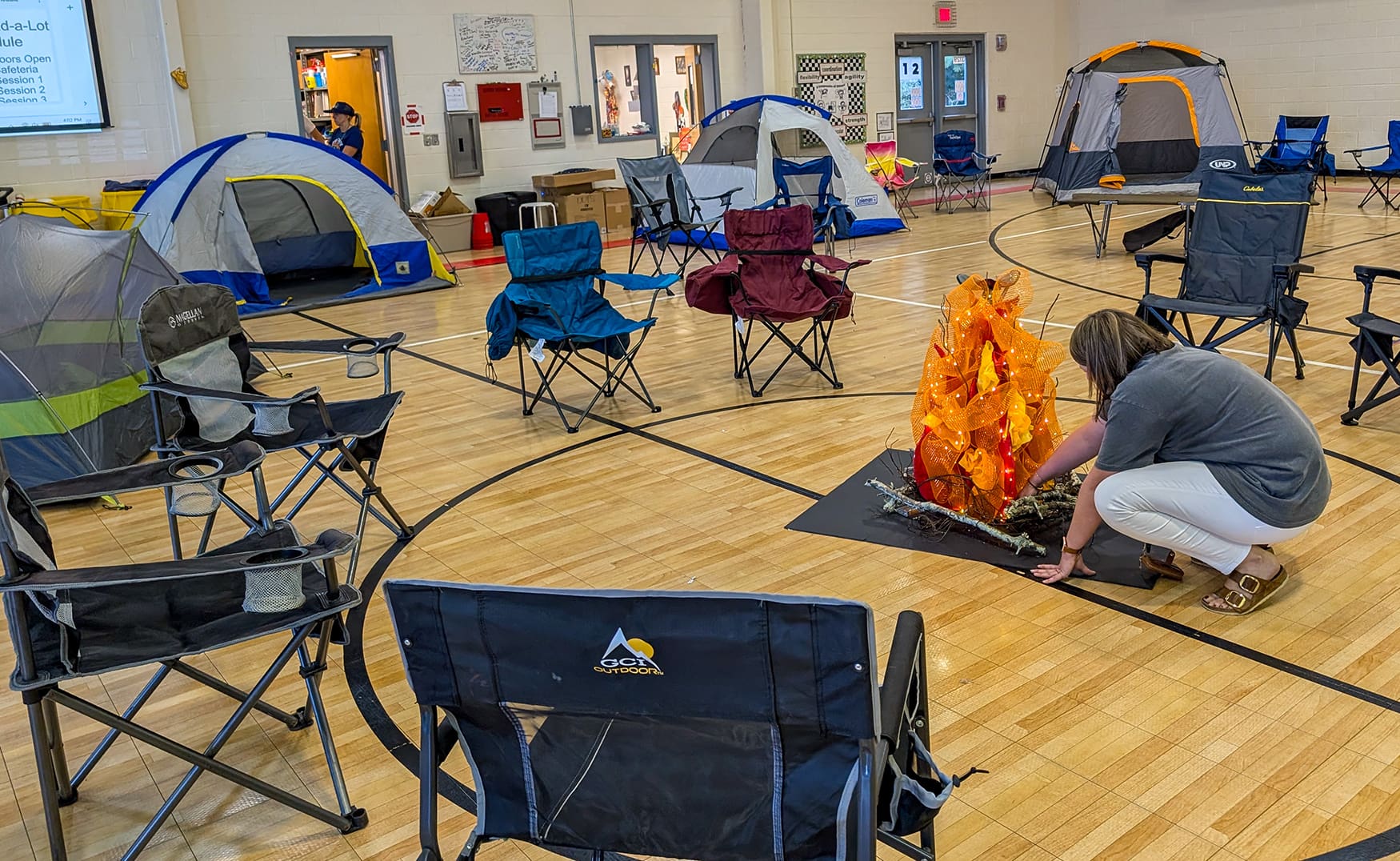 Tents and camp chairs set up in the school gym for Camp Read-A-Lot
